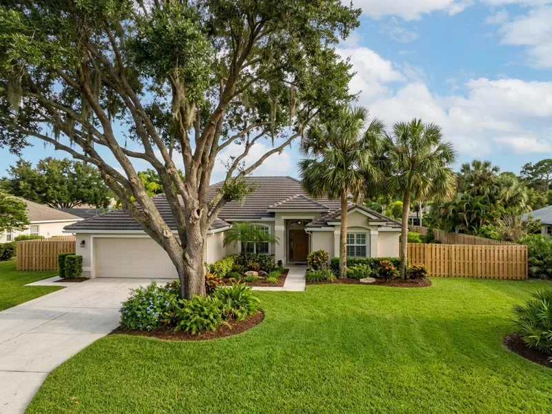 Hyperrealistic photograph of a mature live oak tree and sabal palms in a Port St. Lucie residential front yard showing property lot boundaries